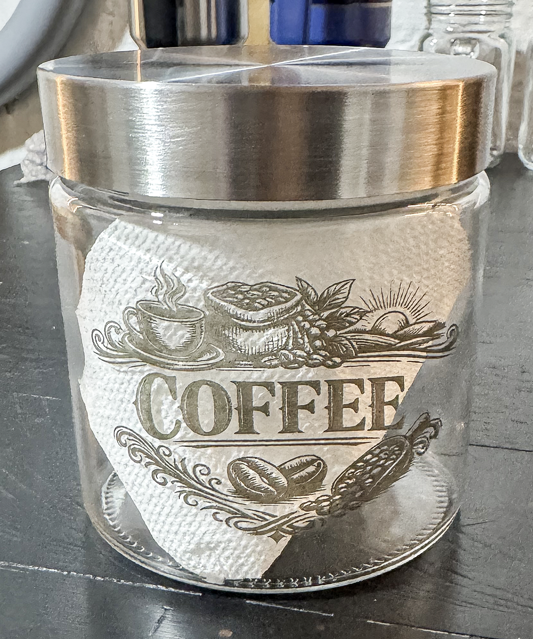 Glass coffee canister with detailed laser engraved coffee artwork