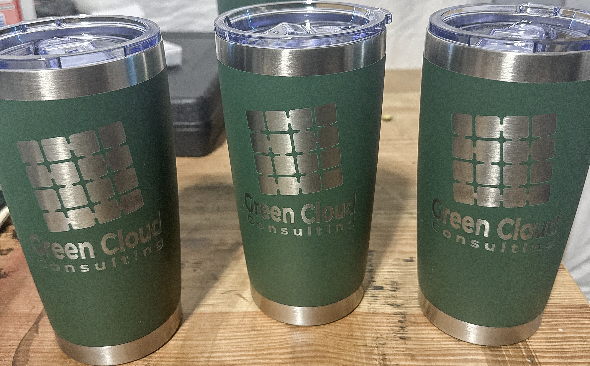 Green powder coated tumblers engraved with Green Cloud Consulting logo